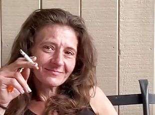 Everyone's favorite Aunt caught smoking and playing with her pussy on the porch.