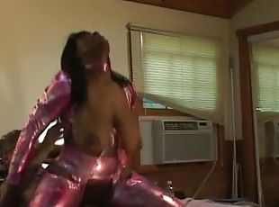 Black girl in shiny catsuit is in control