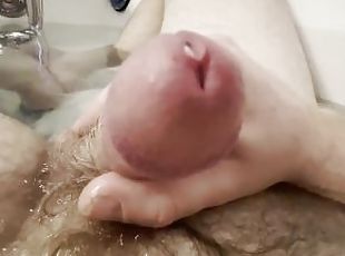 Hairy dick drips cum with toes and feet soaking in the bath