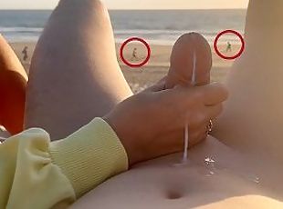 Hand job on a nude beach. We were caught jerking off at sunset near the ocean.